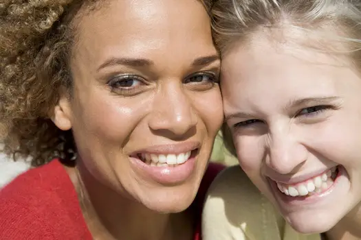 Hugging Your Way To Faster Hair Growth - Close Up Of Two Friends Hugging - HB Media - All Rights Reserved