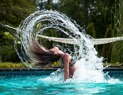 Many Reasons Exist For Dry, Damaged Hair - Image Of Girl In Water - Photo By Chris Hardy On Unsplash.com